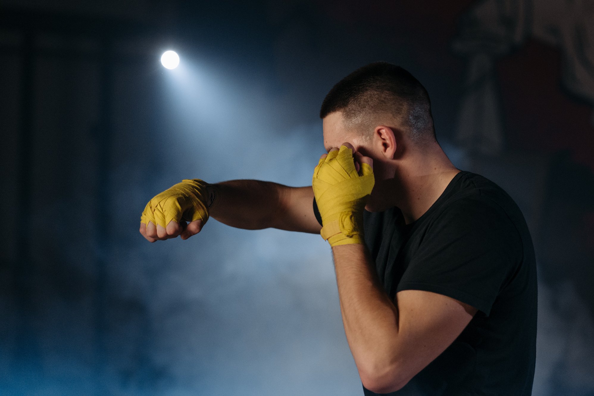 A Man in Black Shirt Wearing Yellow Hand Wraps